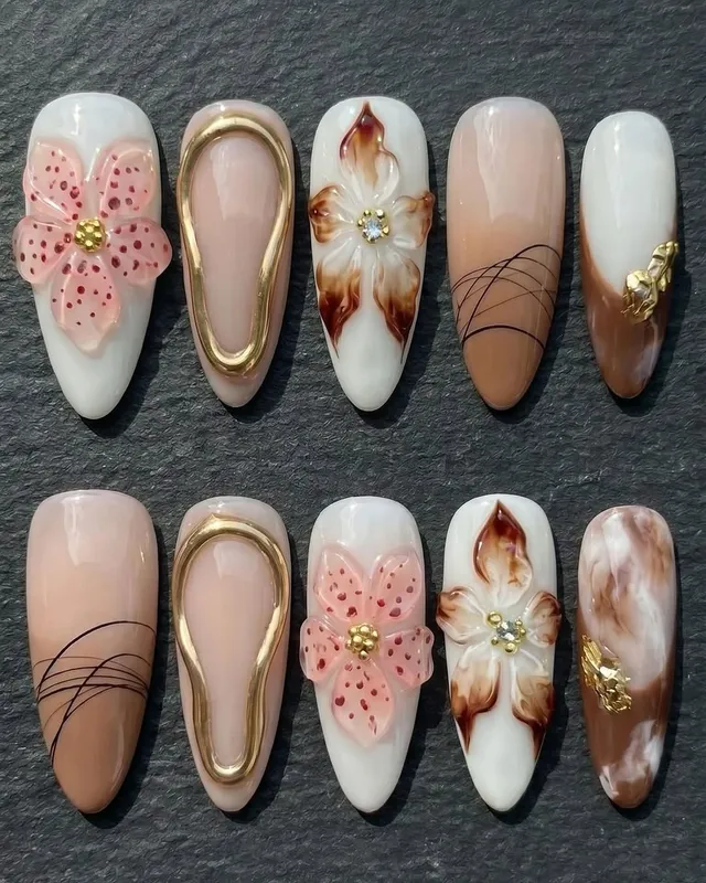 Milky marble nails with molten gold chrome — the Modern Coquette look