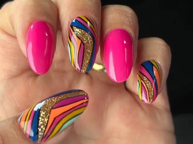 Bright pink and rainbow swirl nails