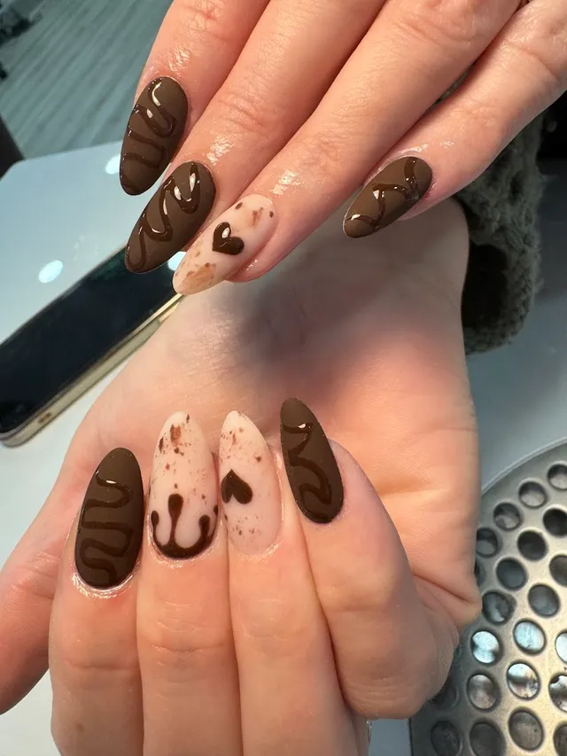 Brown and cream nails with a hand-painted teddy and coffee design